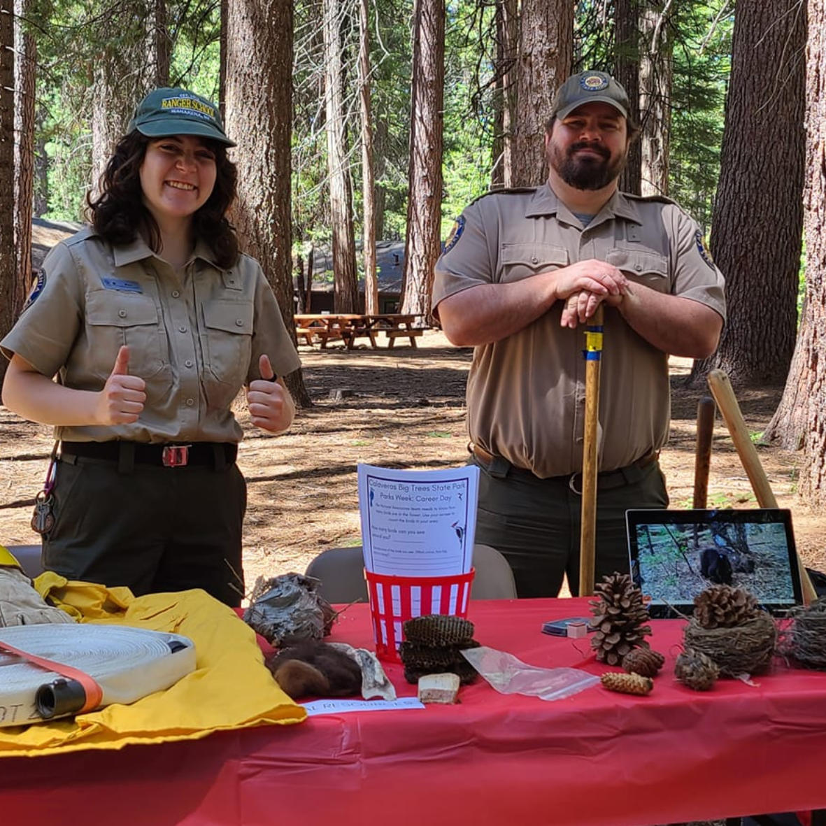 Two staff behind table at event